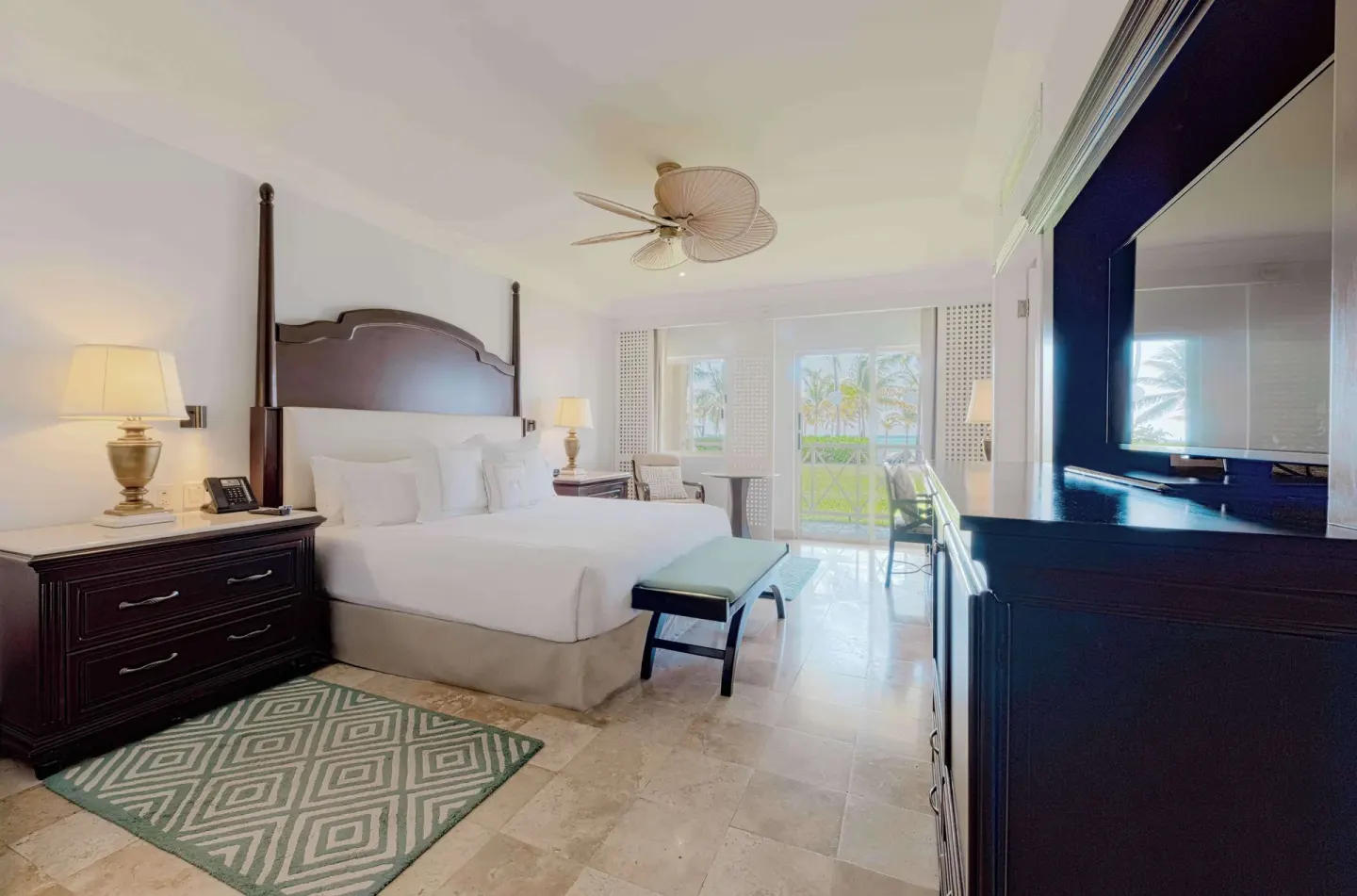 Luxury Room with king bed, nightstands, TV, and balcony doors at Royal Hideaway Playacar.