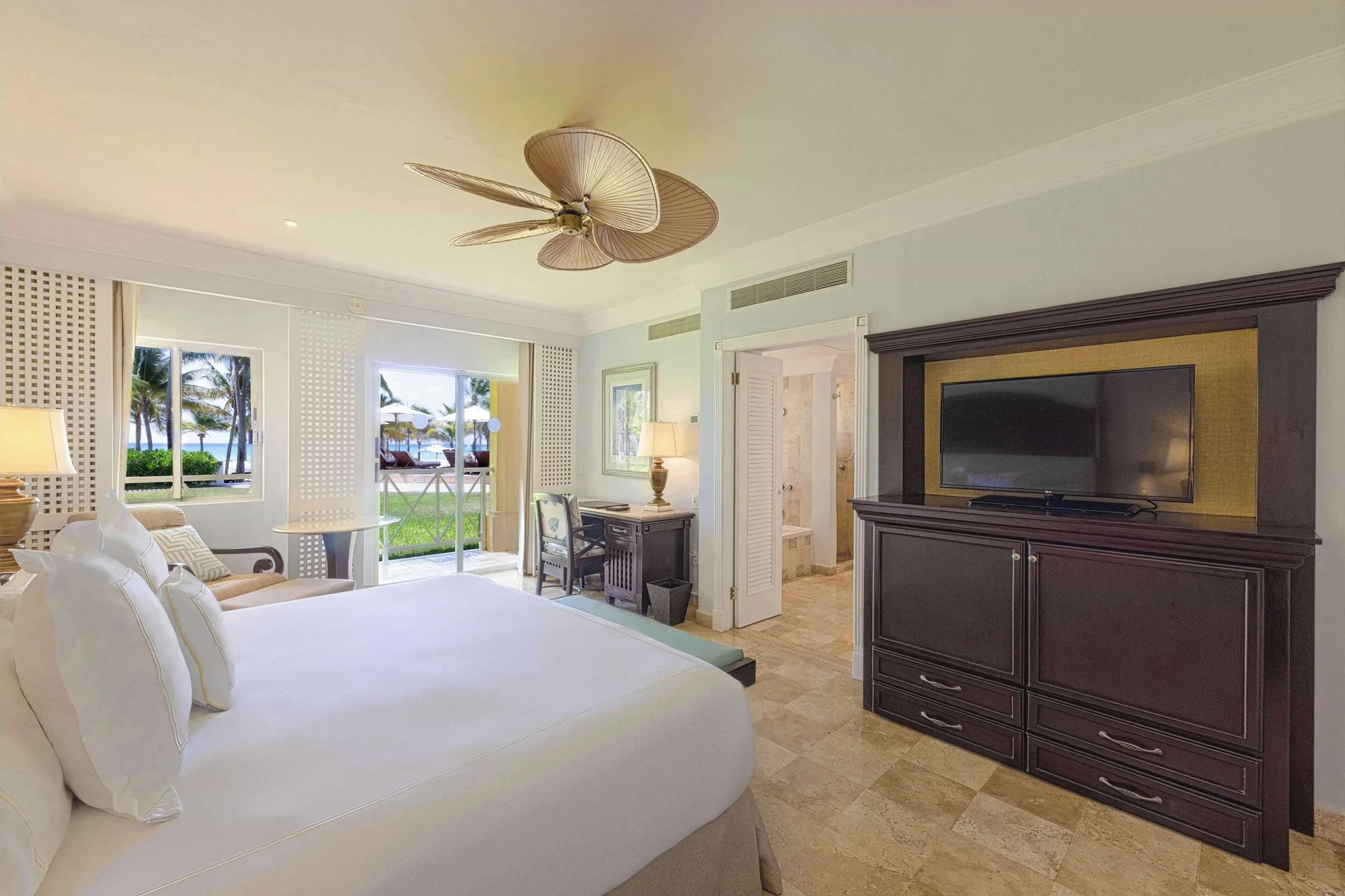 Luxury Room with king bed, TV cabinet, and patio doors at Royal Hideaway Playacar.