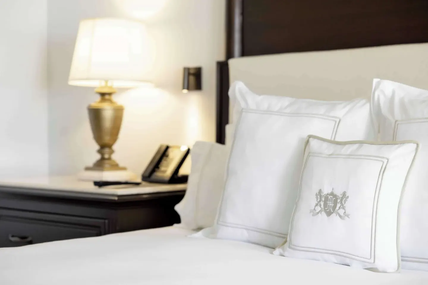Luxury Room bed pillows and bedside lamp close-up at Royal Hideaway Playacar.