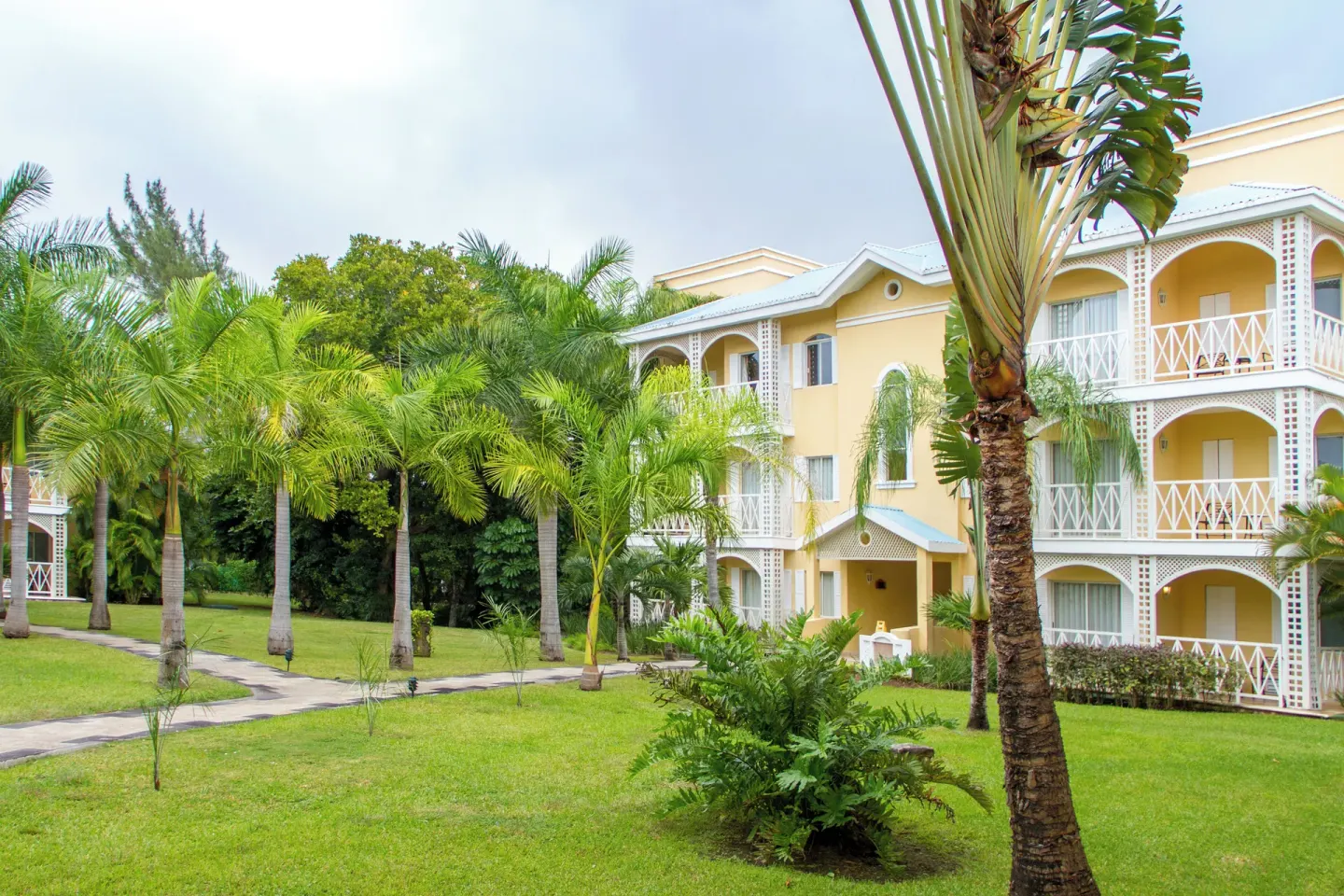 Guest room building and tropical garden at Royal Hideaway Playacar.
