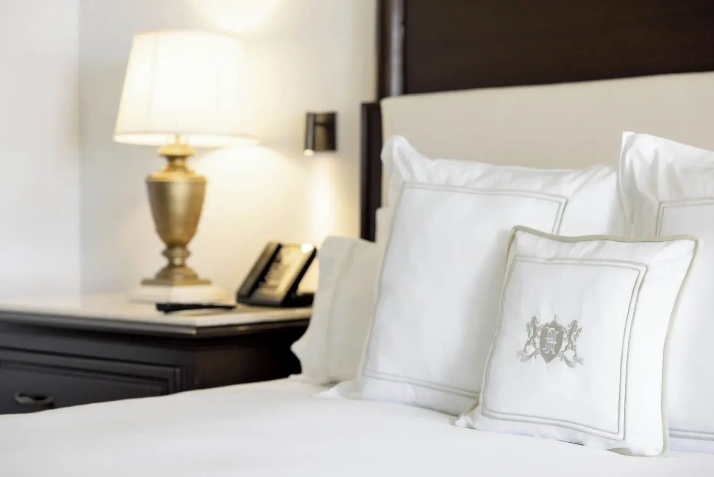 Luxury Room king bed pillows and bedside lamp at Royal Hideaway Playacar.