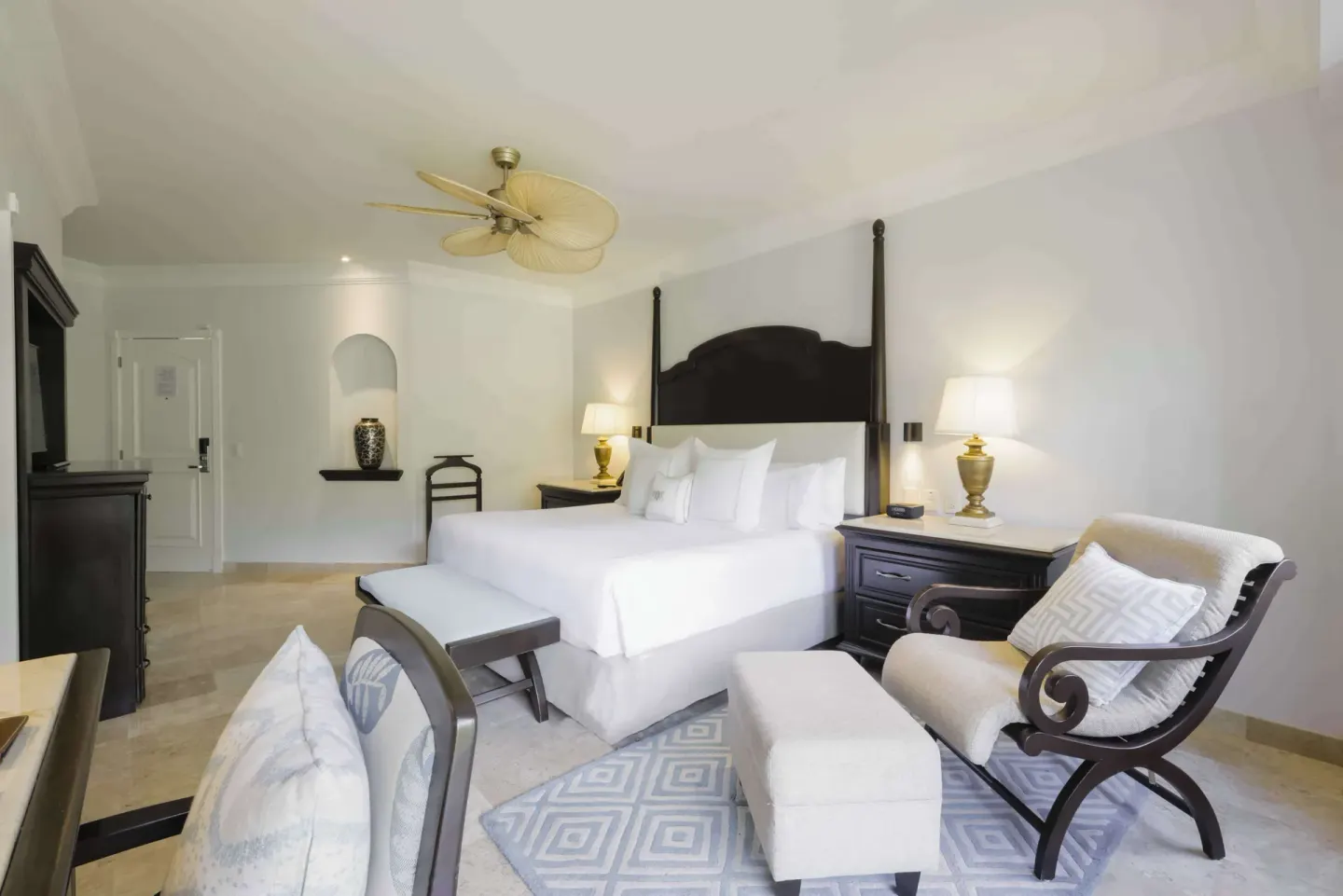 Luxury Room with king bed and seating area at Royal Hideaway Playacar.