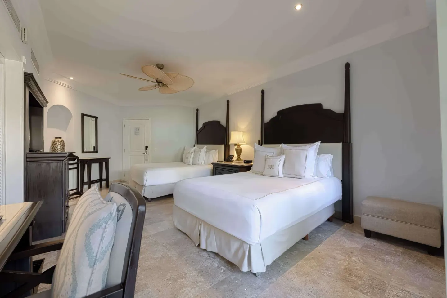 Luxury Room with two beds and dark wood headboards at Royal Hideaway Playacar.
