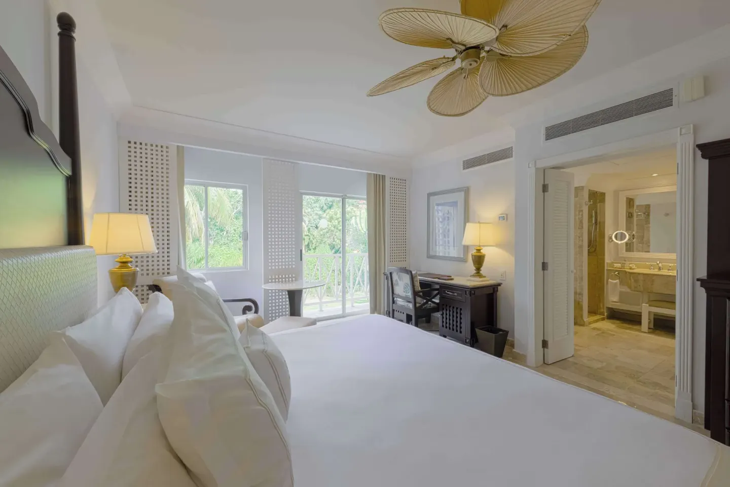 Luxury Royal Hideaway Playacar with king bed, balcony doors, and bathroom at Royal Hideaway Playacar.