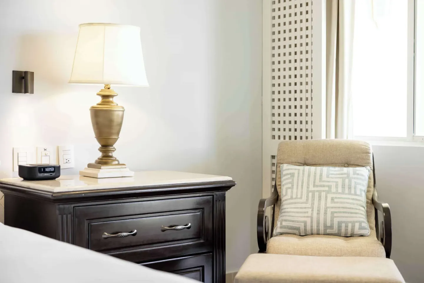 Luxury Royal Hideaway Playacar nightstand and lounge chair at Royal Hideaway Playacar.