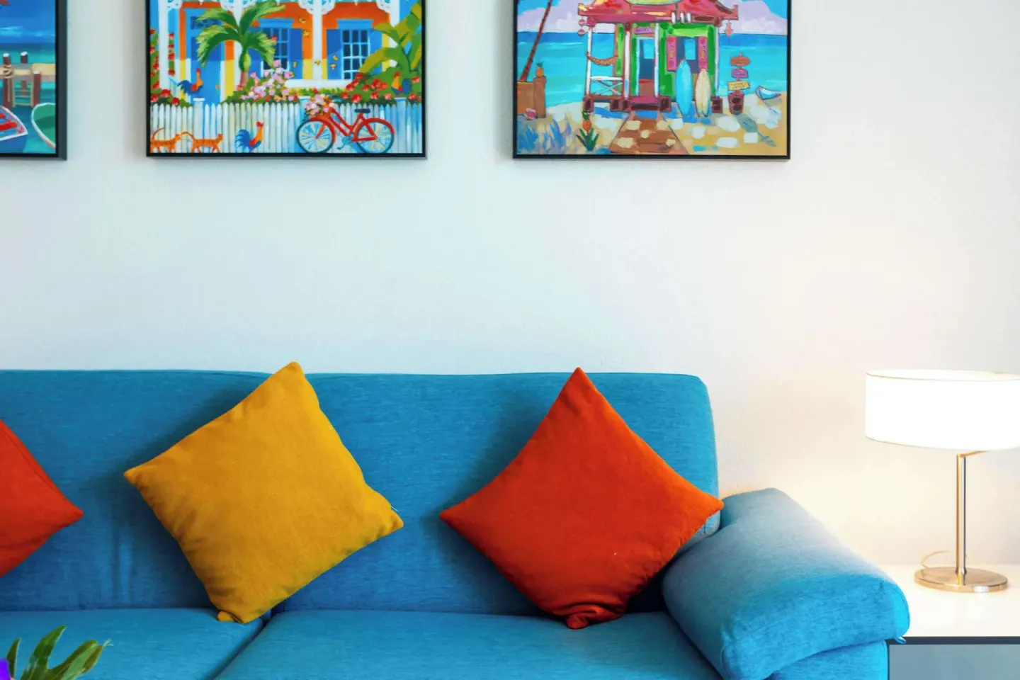 Blue sofa with colorful pillows in a guest room at Royal Islander Resort La Plage.