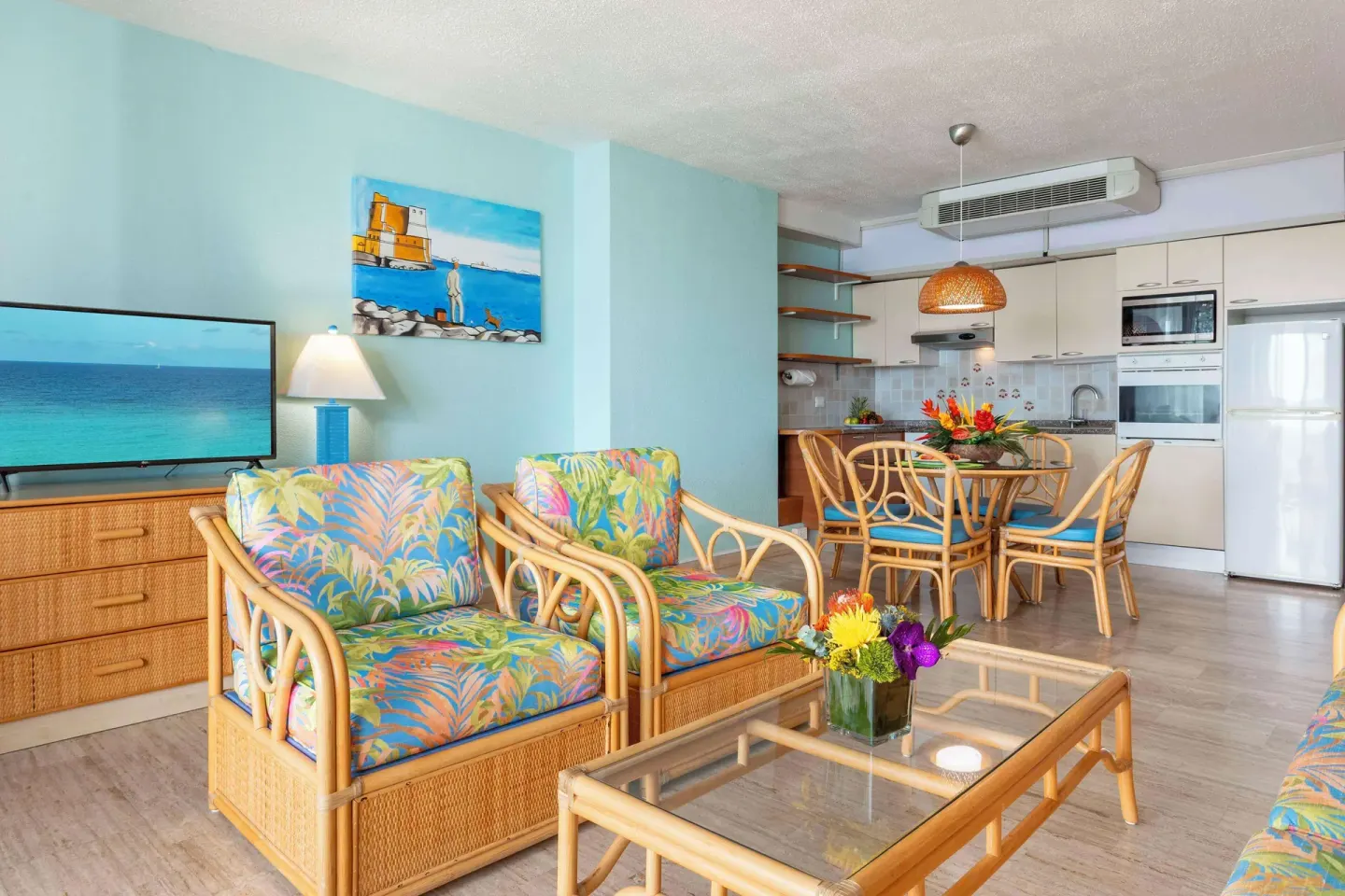 Rattan lounge chairs beside a dining area at Royal Islander Resort La Plage.