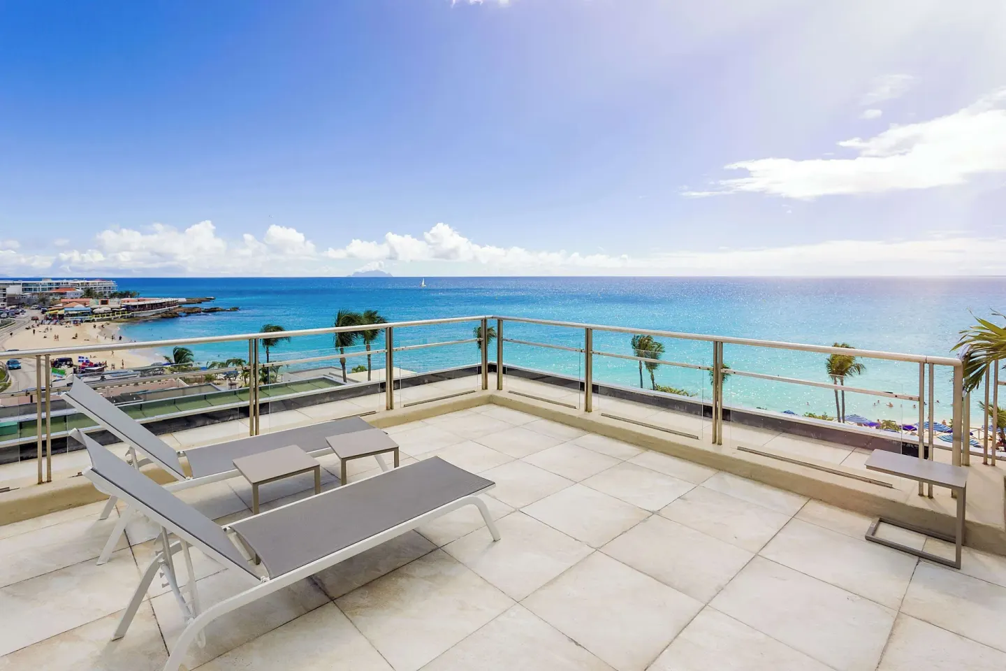 Oceanfront terrace with loungers overlooking the beach at Royal Islander Resort La Plage.