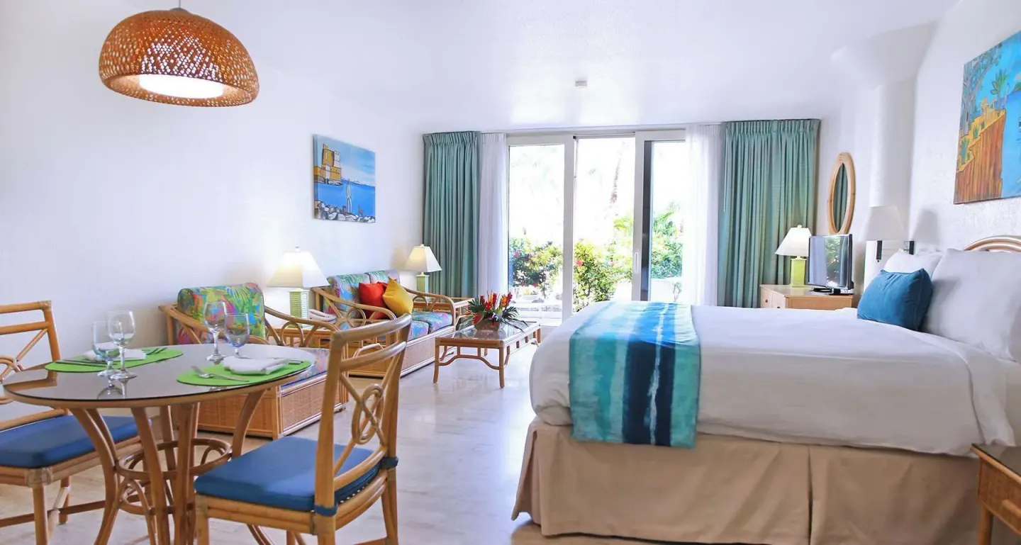 King bed studio with dining table and sitting area at Royal Islander Resort La Plage.