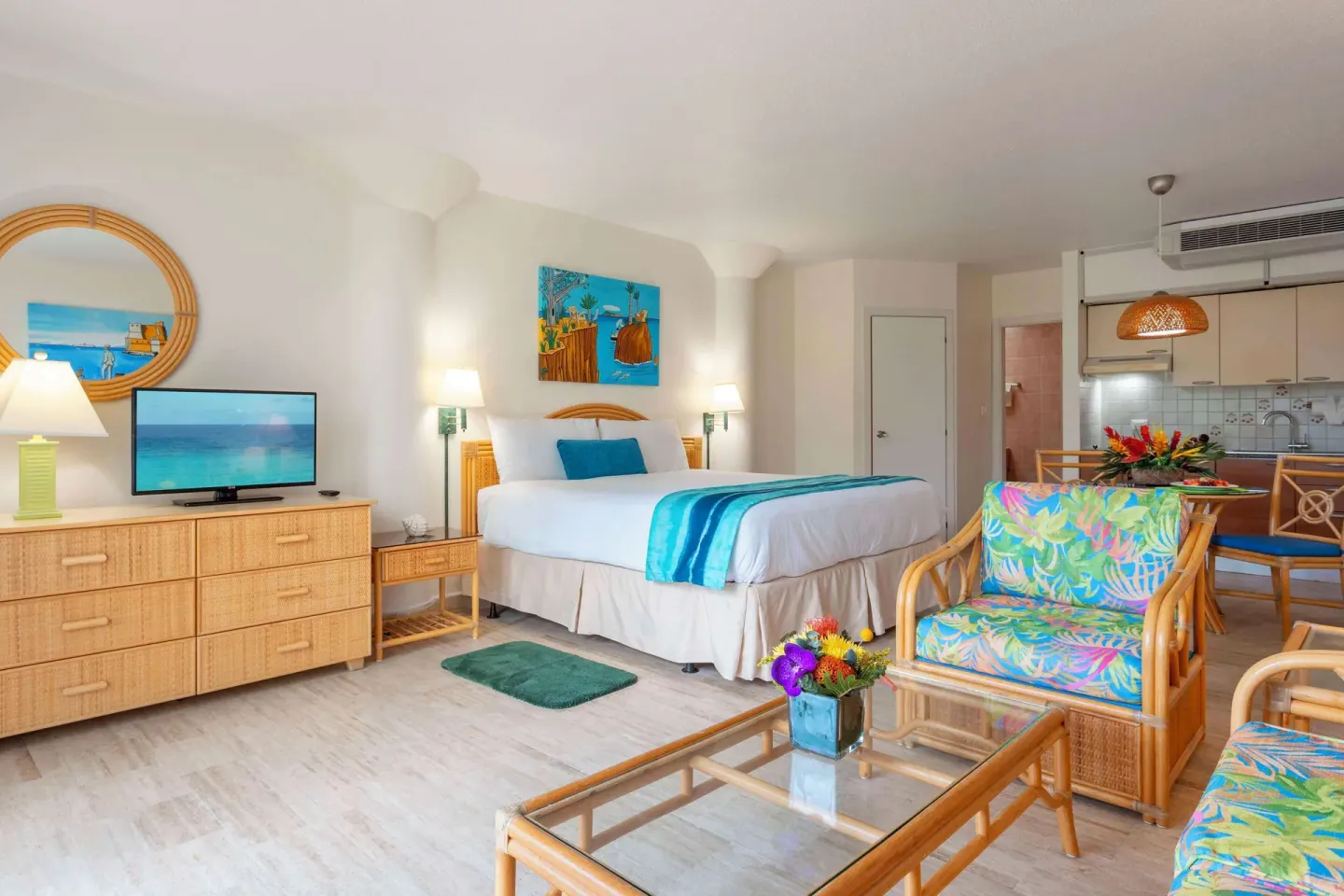 King bed studio with rattan seating and kitchenette at Royal Islander Resort La Plage.