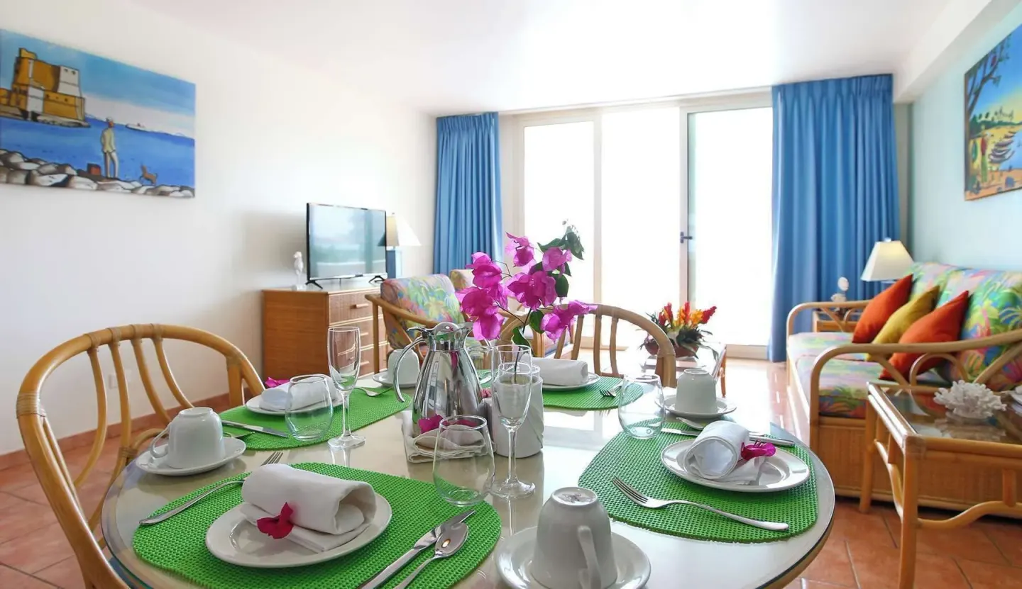 Dining table set in a suite living area at Royal Islander Resort La Plage.