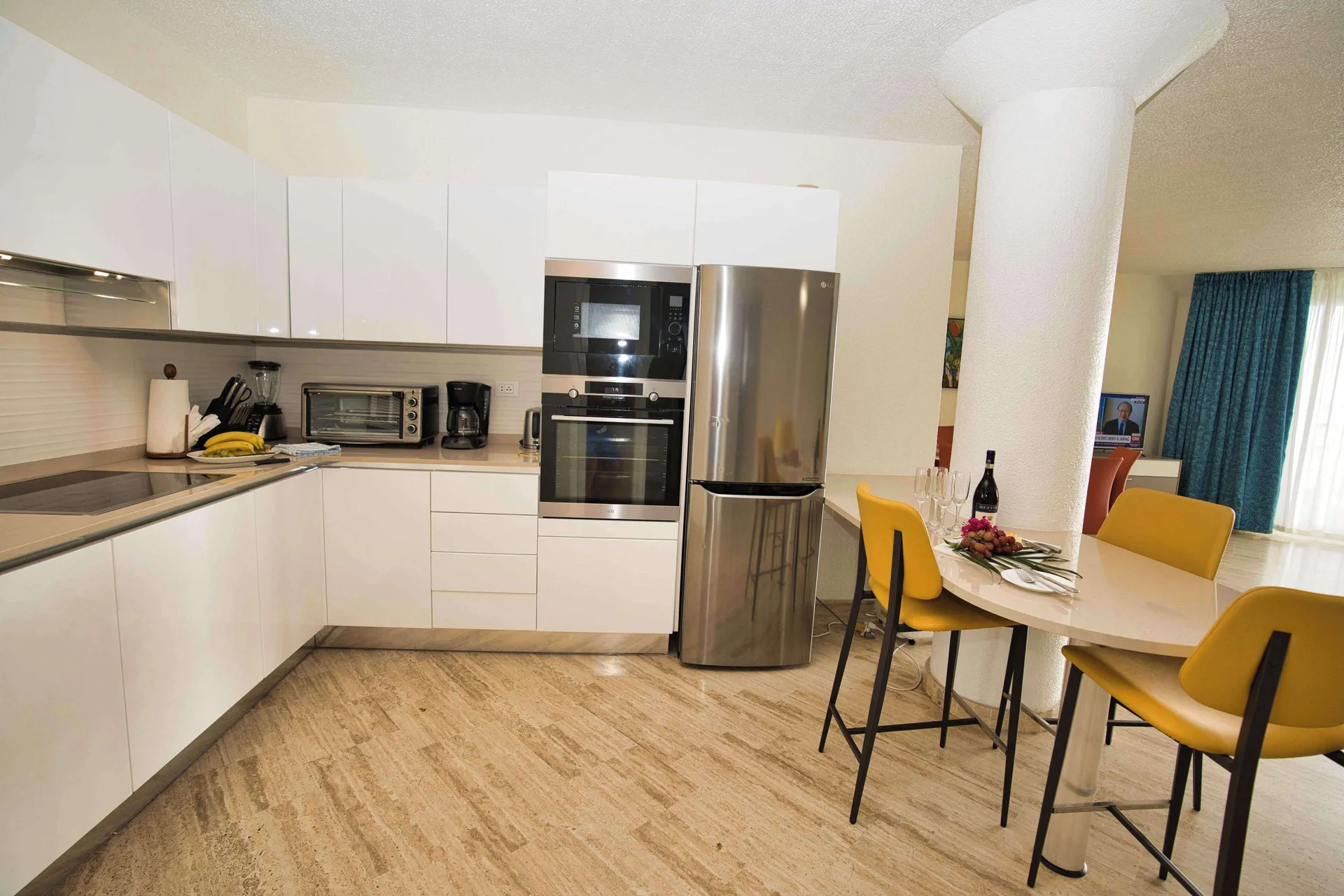 White suite kitchen and dining table at Royal Islander Resort La Plage.