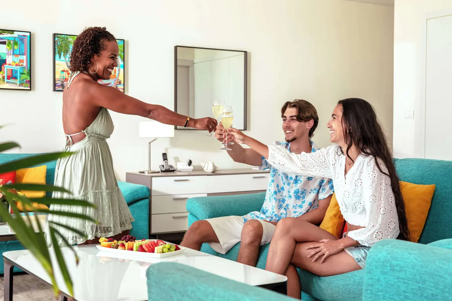 Guests toasting in a suite living room at Royal Islander Resort La Plage.