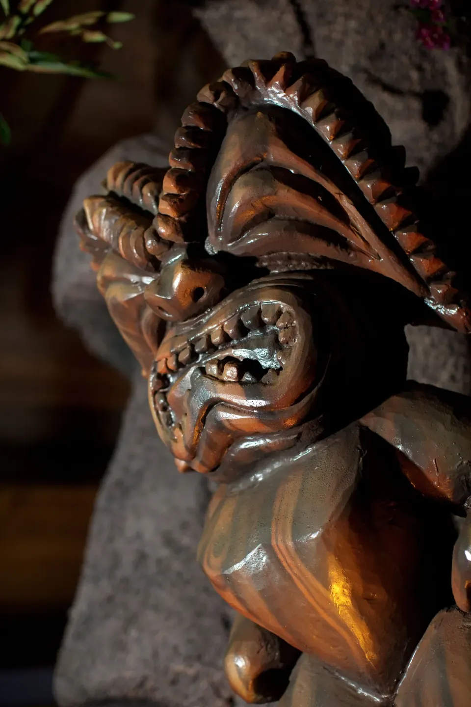 A carved wooden tiki figure is shown in close-up at Royal Kona Resort.