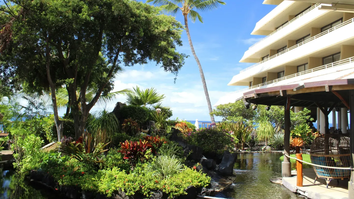 Lush gardens and water features border the resort building at Royal Kona Resort.