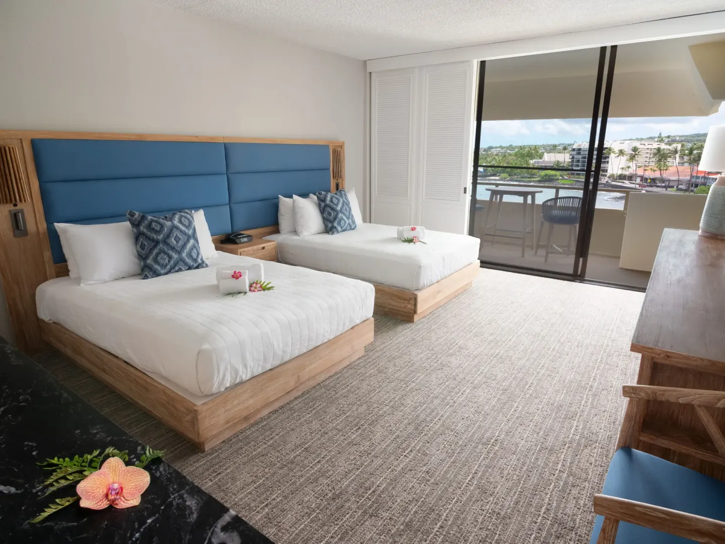 Renovated ocean view room with two beds and balcony at Royal Kona Resort.