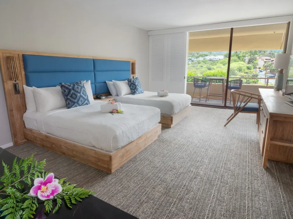 Standard room with two beds, balcony seating, and hillside view at Royal Kona Resort.