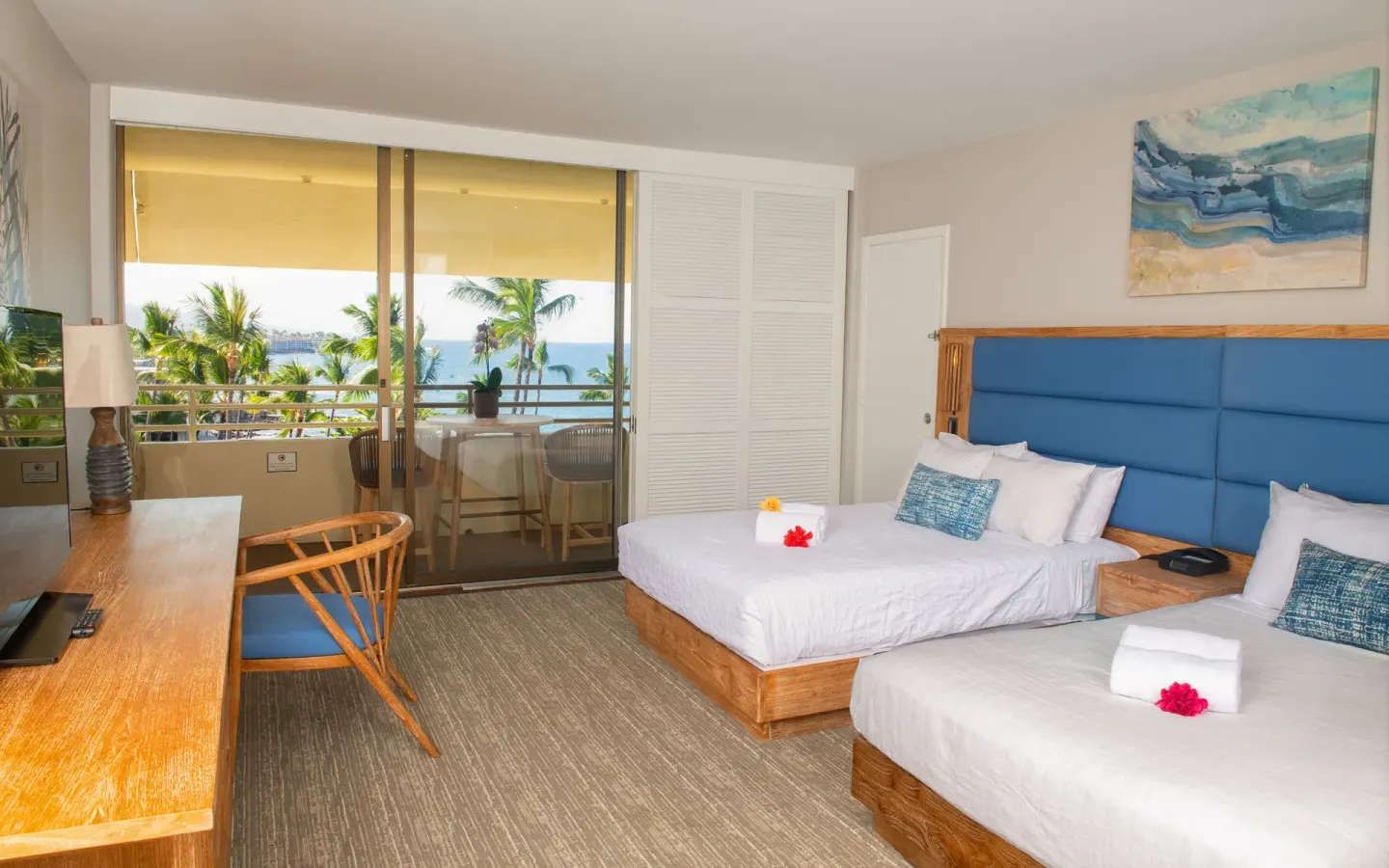 Ocean View room with two beds, desk and balcony overlooking palms at Royal Kona Resort.
