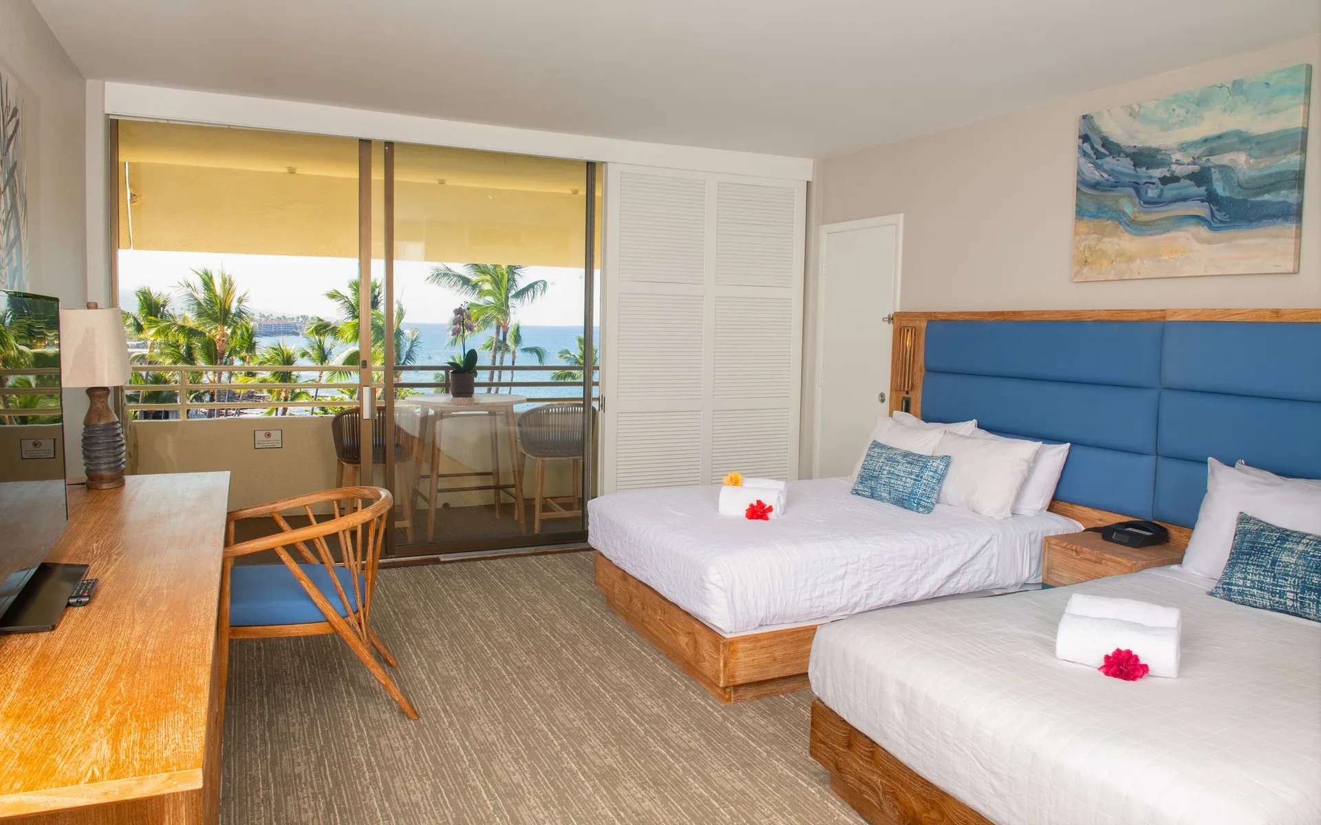 Ocean View room with two beds, desk and balcony overlooking palms at Royal Kona Resort.