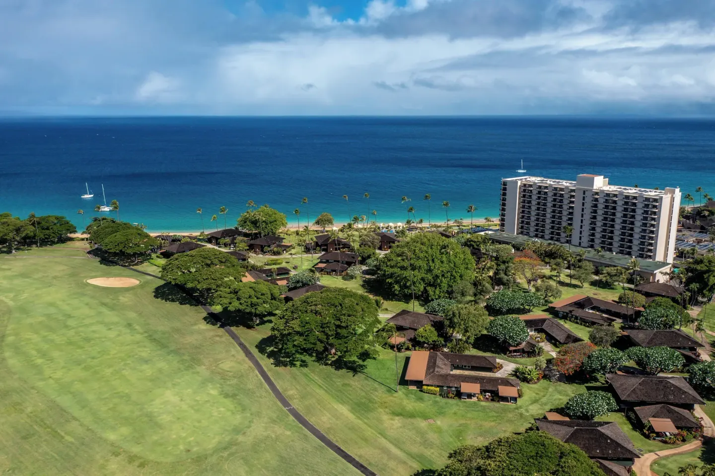 Aerial view of Royal Lahaina Resort & Bungalows beside the beach and ocean.