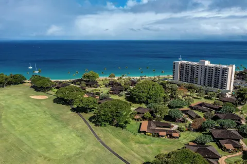 Aerial view of Royal Lahaina Resort & Bungalows beside the beach and ocean.