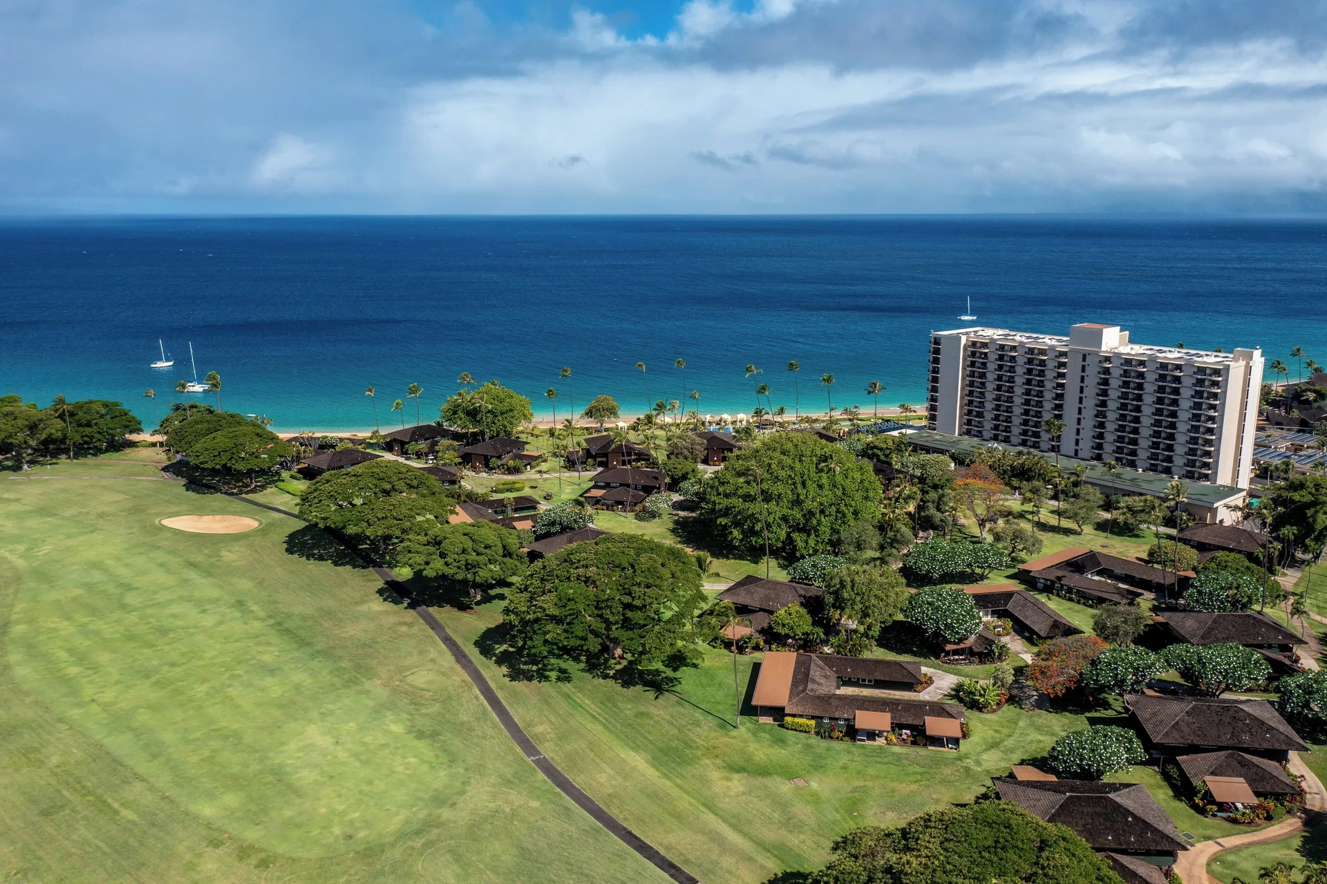 Aerial view of Royal Lahaina Resort & Bungalows beside the beach and ocean.