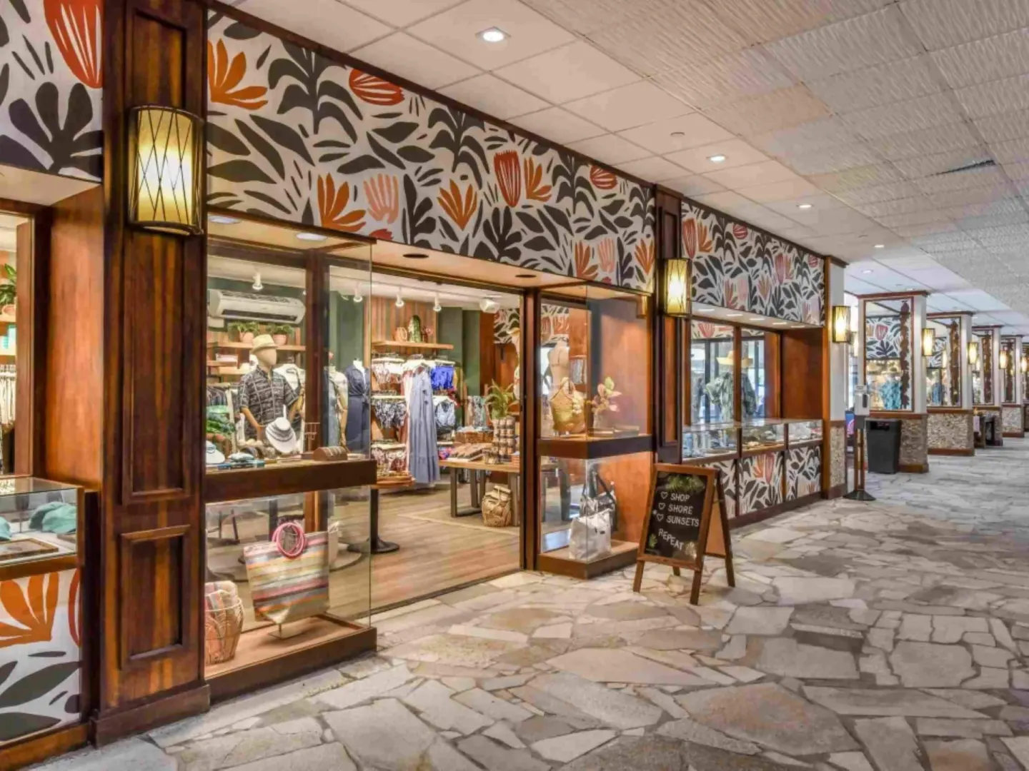 Boutique storefront with display windows and tropical wall patterns at Royal Lahaina Resort & Bungalows.