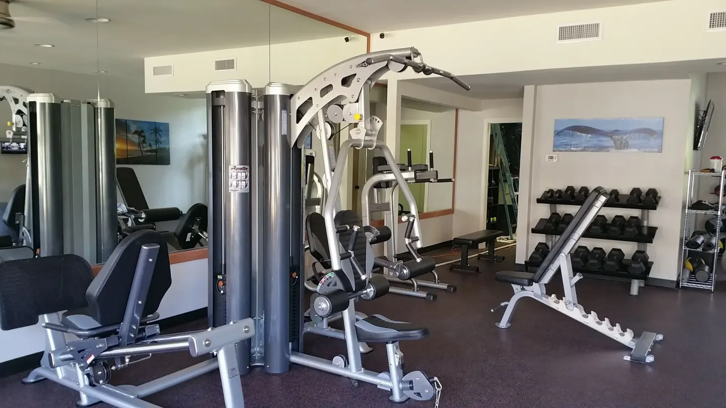 Fitness room with weight machines and dumbbells at Royal Lahaina Resort & Bungalows.