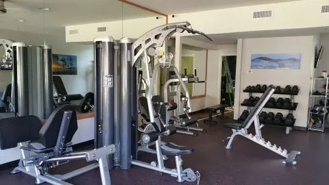 Fitness room with weight machines and dumbbells at Royal Lahaina Resort & Bungalows.
