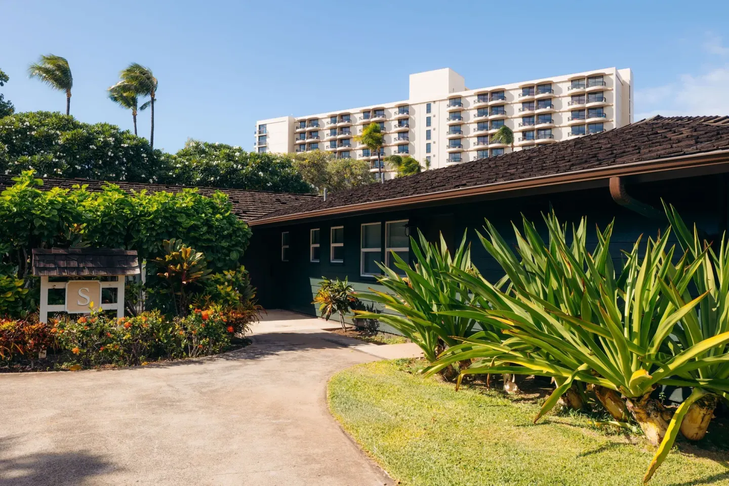 Garden bungalow walkway and resort tower at Royal Lahaina Resort & Bungalows.