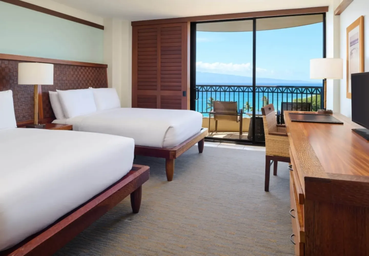Guest room at Royal Lahaina Resort & Bungalows with two beds, desk, balcony, and ocean view.