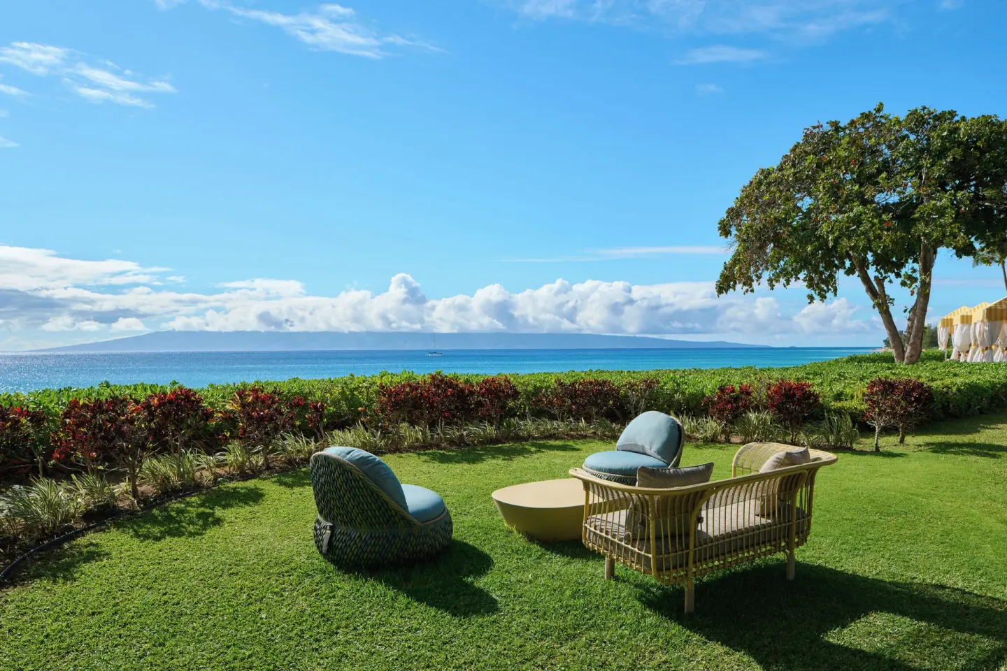 Oceanfront lawn seating with chairs and a sofa at Royal Lahaina Resort & Bungalows.