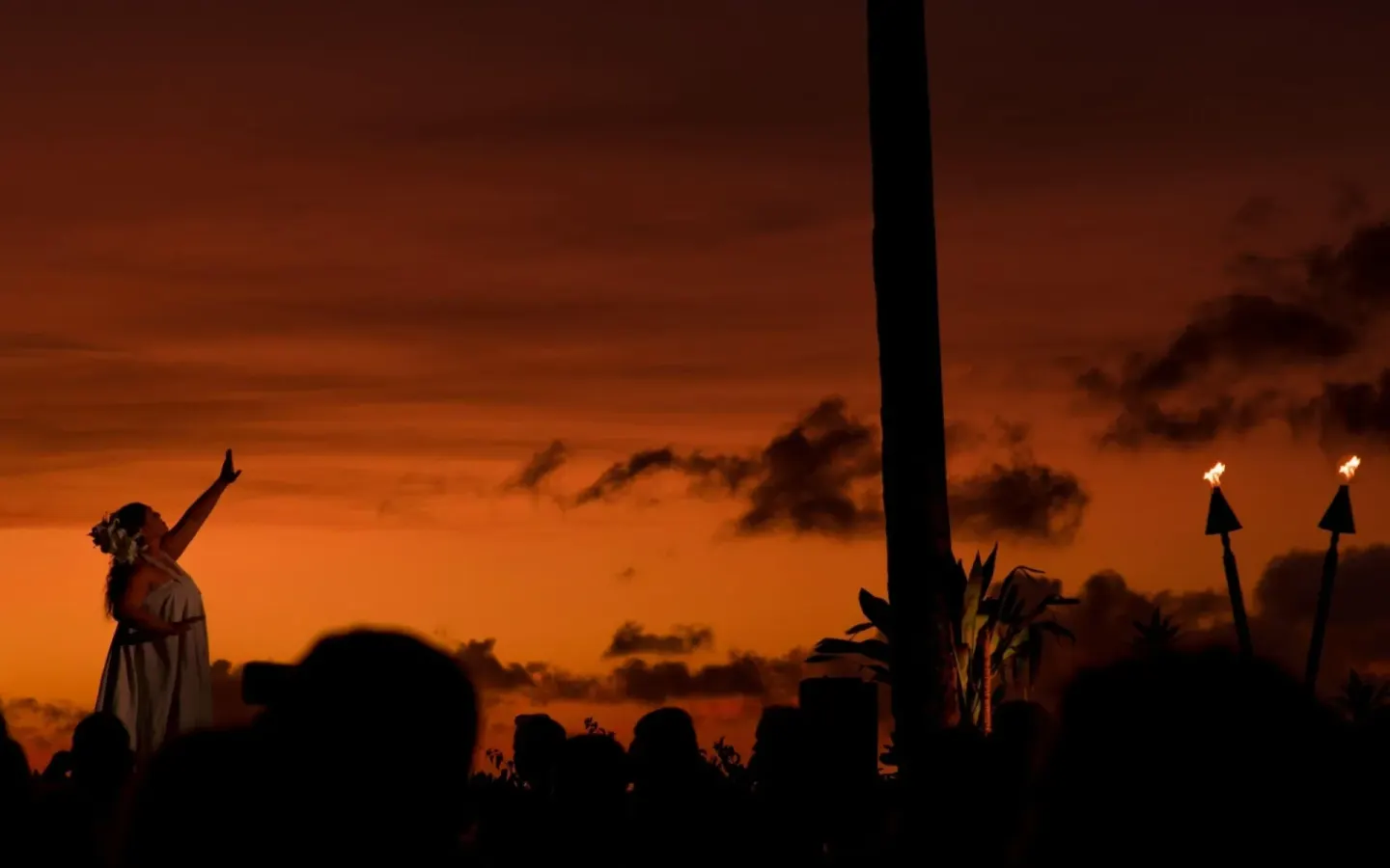 Sunset torch-lighting performance silhouetted at Royal Lahaina Resort & Bungalows.