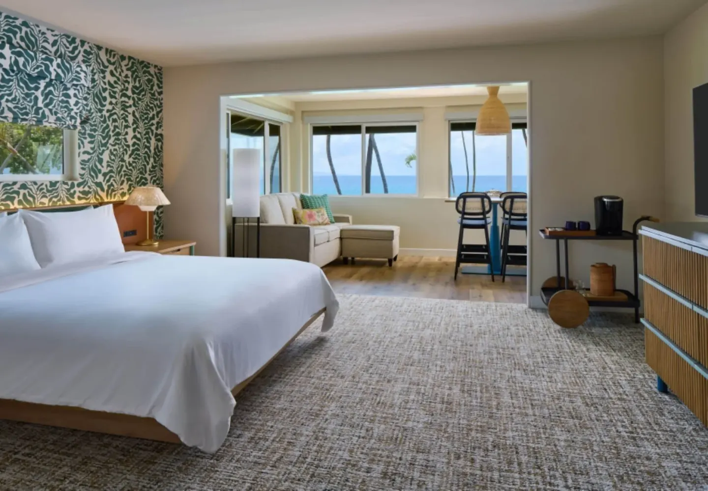 Oceanfront bungalow junior suite with king bed and sitting area at Royal Lahaina Resort & Bungalows.