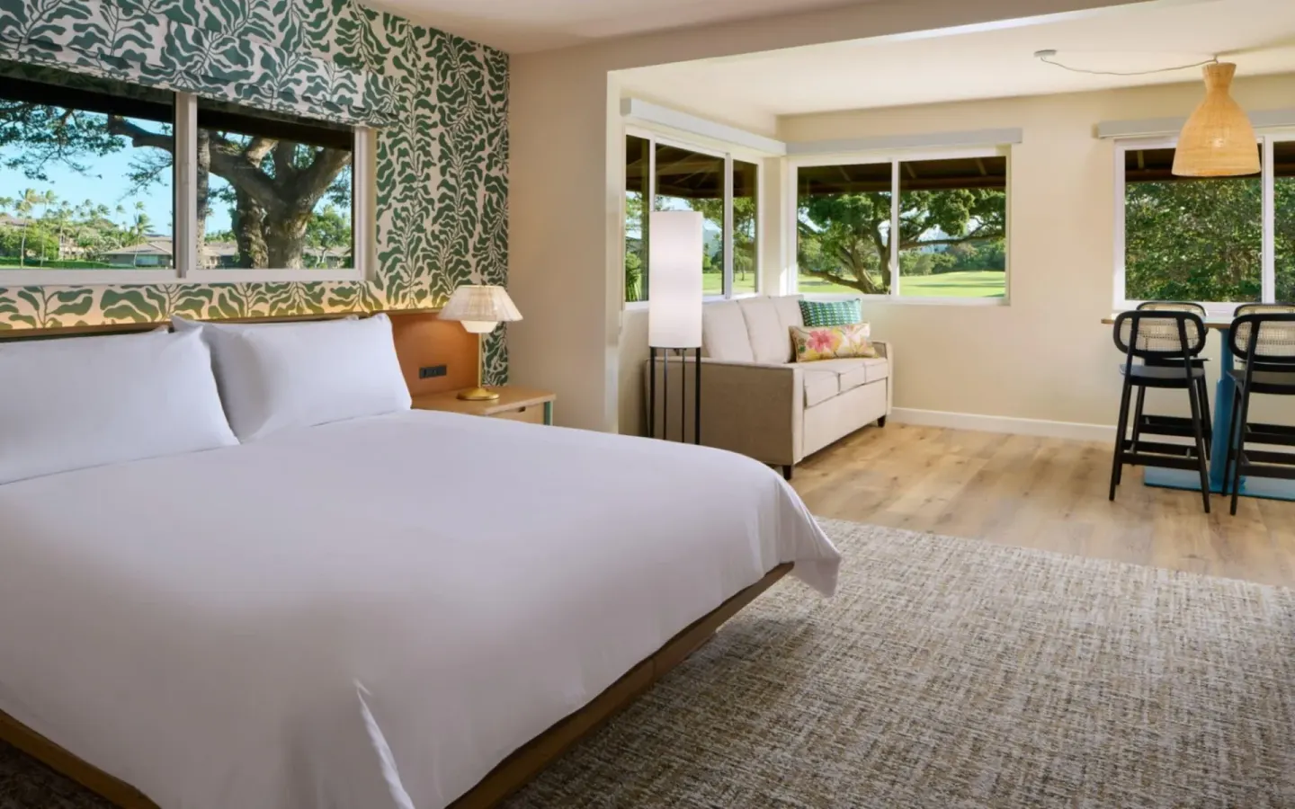 Bungalow Junior Suite bedroom with king bed and sitting area at Royal Lahaina Resort & Bungalows.