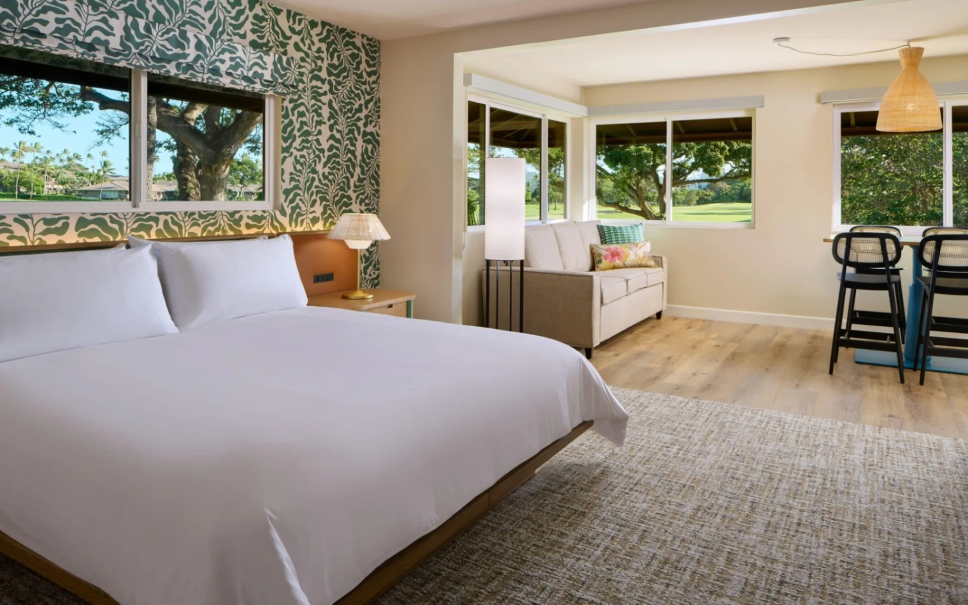 Bungalow Junior Suite bedroom with king bed and sitting area at Royal Lahaina Resort & Bungalows.