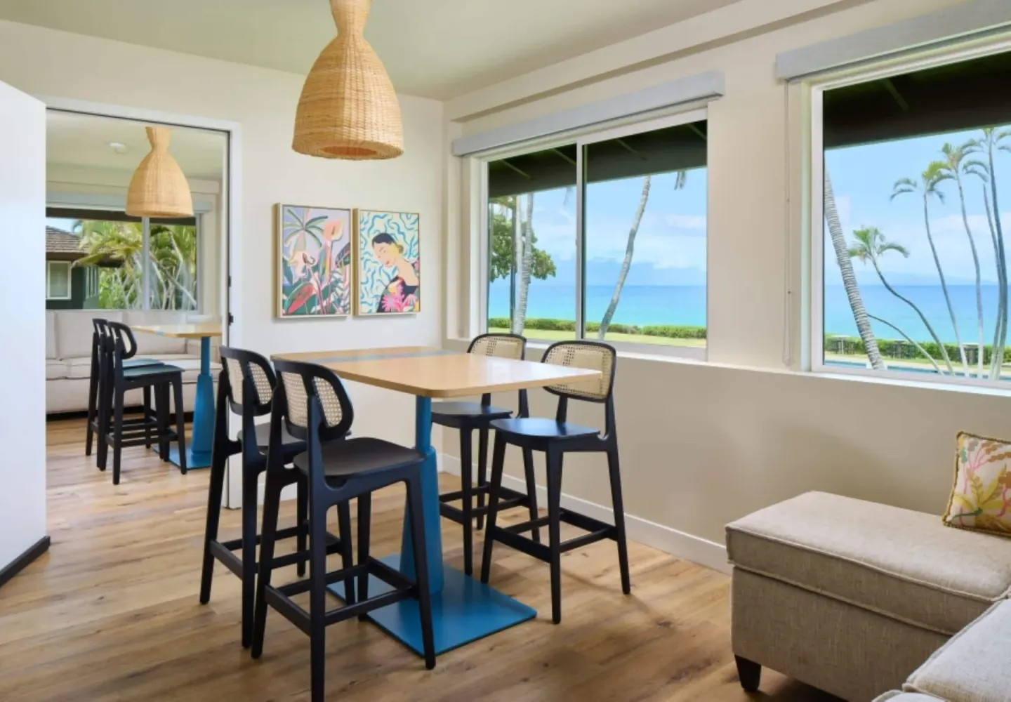Oceanfront bungalow dining area with table and windows at Royal Lahaina Resort & Bungalows.