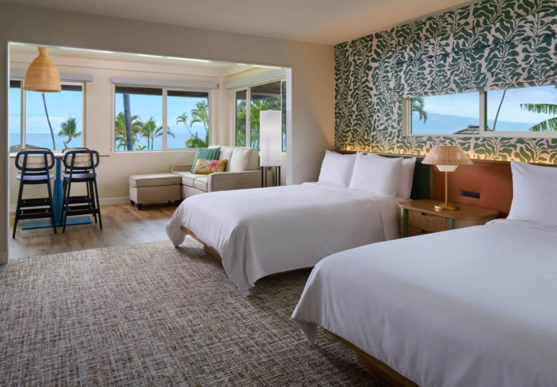 Oceanfront bungalow studio with two beds and seating at Royal Lahaina Resort & Bungalows.