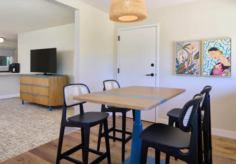 Dining table and TV area in a Bungalow Studio Suite with Kitchen at Royal Lahaina Resort & Bungalows.