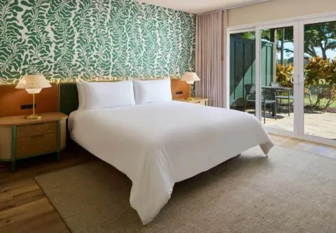 King bed in a bungalow room with lanai access at Royal Lahaina Resort & Bungalows.