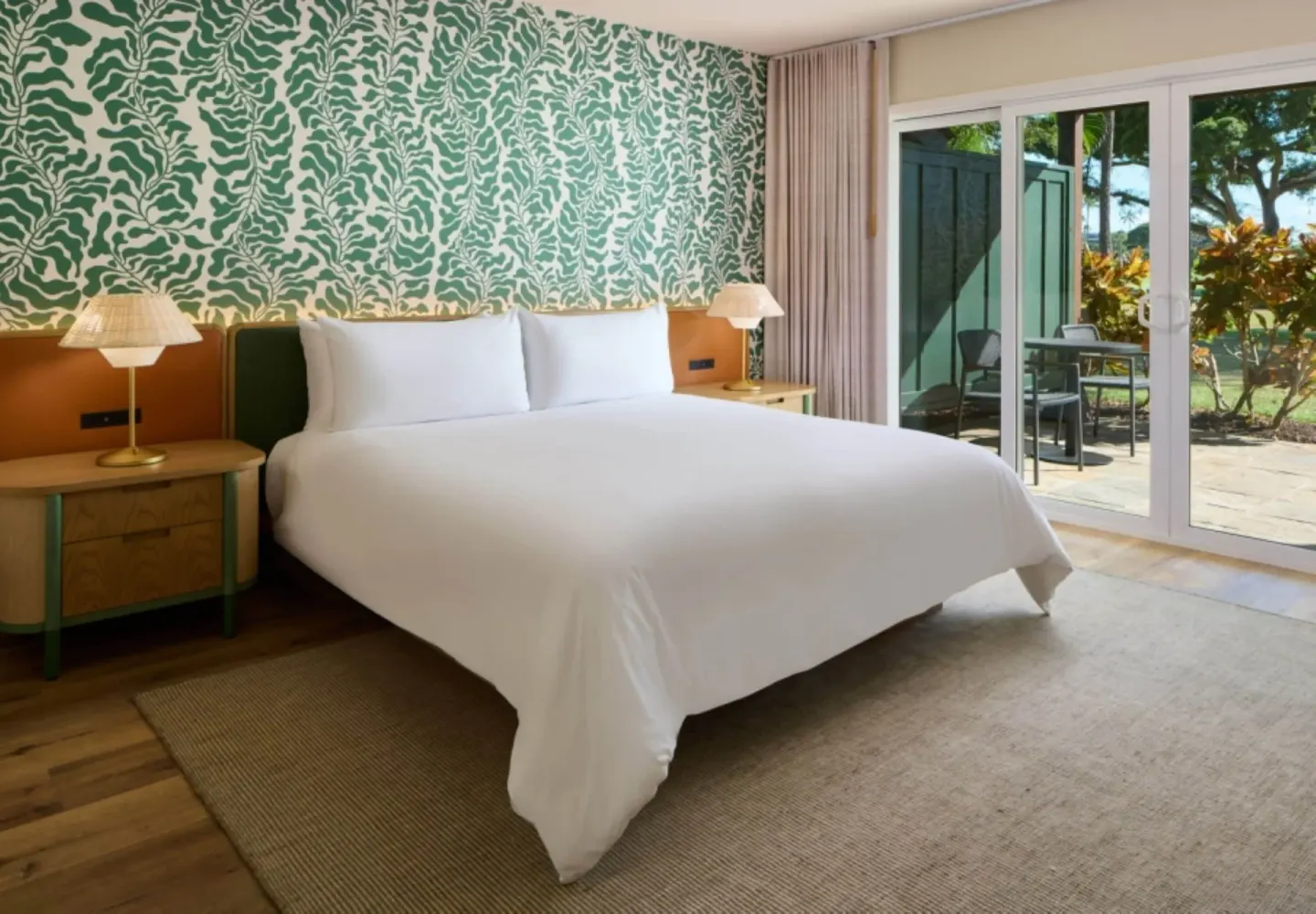 Bungalow with lanai king bed and patio doors at Royal Lahaina Resort & Bungalows.