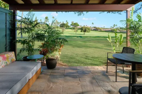 Covered bungalow lanai with seating and lawn views at Royal Lahaina Resort & Bungalows.