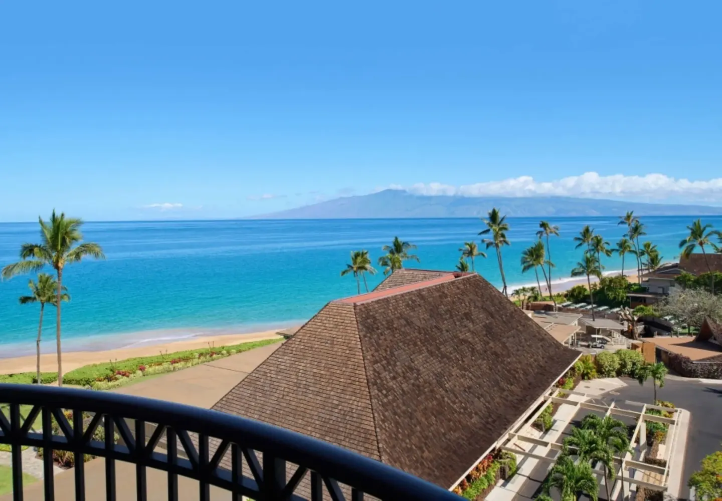 Ocean View ADA balcony view of beach, ocean, and palms at Royal Lahaina Resort & Bungalows.
