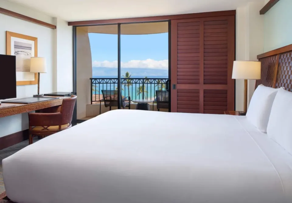 Ocean View ADA guest room with king bed and balcony at Royal Lahaina Resort & Bungalows.