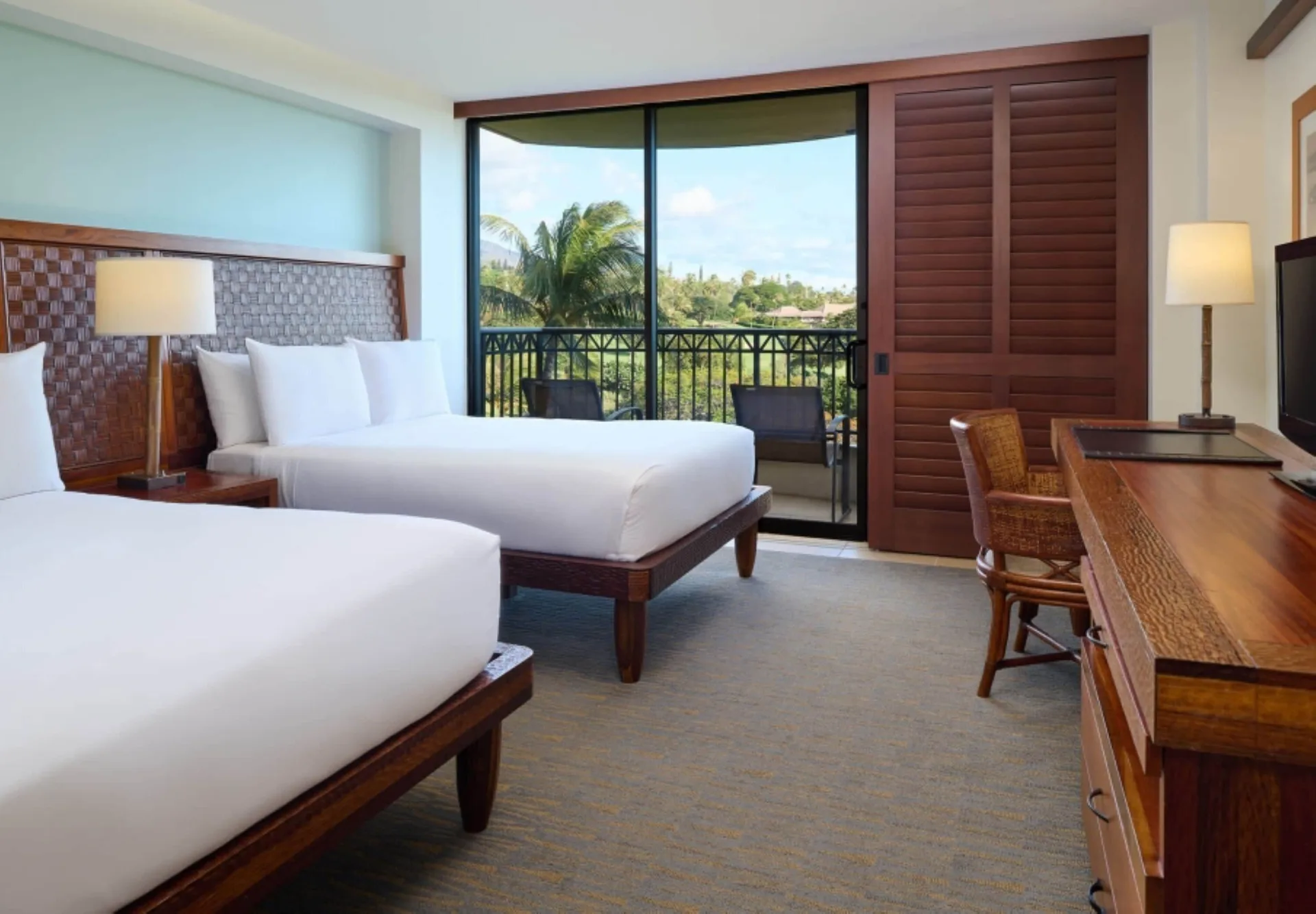 Partial Ocean View Room with two beds and balcony at Royal Lahaina Resort & Bungalows.