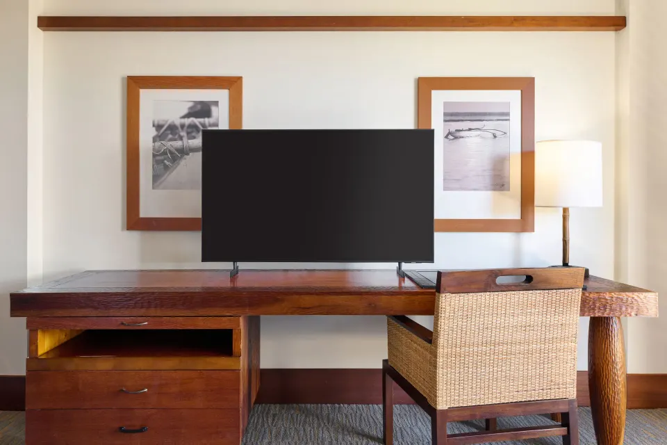 Partial Ocean View room desk with TV and chair at Royal Lahaina Resort & Bungalows.
