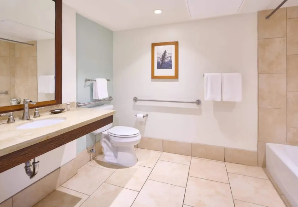 Accessible bathroom vanity and grab bars in a Resort View Two ADA room at Royal Lahaina Resort & Bungalows.