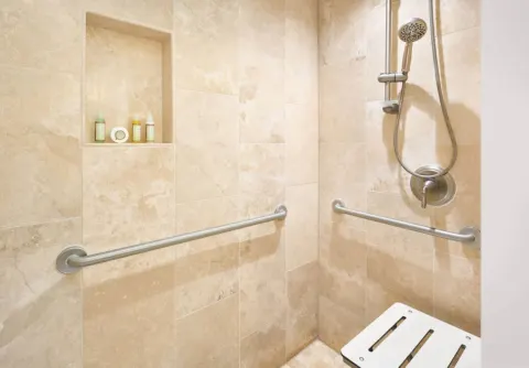Roll-in shower with grab bars in a Resort View Two ADA room at Royal Lahaina Resort & Bungalows.