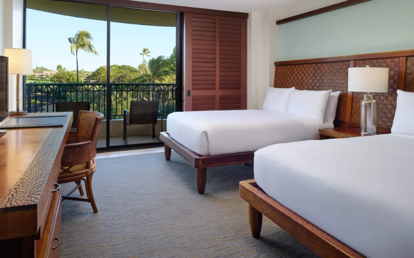Two beds and a balcony in a Resort View Two ADA room at Royal Lahaina Resort & Bungalows.
