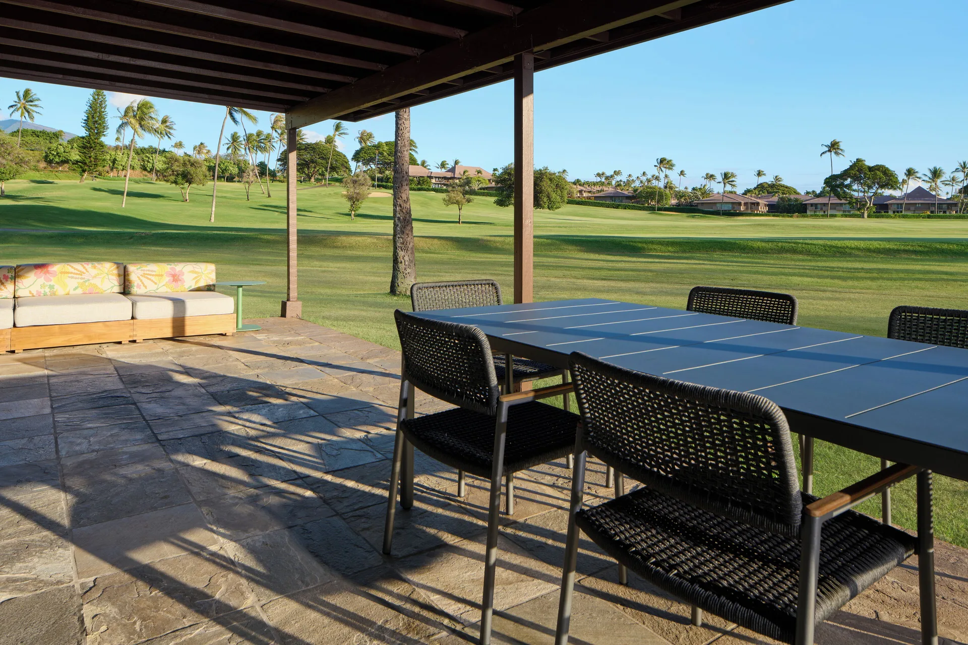 Covered patio of a Royal Lahaina Resort & Bungalows at Royal Lahaina Resort & Bungalows with lawn views.